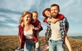 Happy family: mother, father, children son and daughter playing in nature against a blue sky Royalty Free Stock Photo