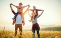 Happy family: mother, father, children son and daughter standing and hugging on sunset Royalty Free Stock Photo