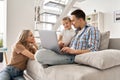 Happy family mother, father and cute child son having fun using laptop at home. Royalty Free Stock Photo