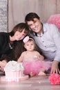 Happy family - mother, father and daughter celebrating first birthday with cake. Royalty Free Stock Photo