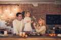 Happy family - Mother, father and daughter play and cook Christmas cookies in the loft-style kitchen
