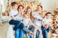 Happy family mother father five children relax playing near Christmas tree on Christmas eve at home. Mom dad daughter Royalty Free Stock Photo