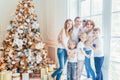 Happy family mother father five children relax playing near Christmas tree on Christmas eve at home. Mom dad daughter Royalty Free Stock Photo