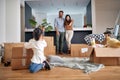 Family- mother father and girl move to new apartment and unpack boxes Royalty Free Stock Photo