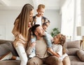 Happy family mother father and kids having fun at home on couch Royalty Free Stock Photo