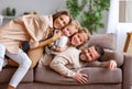 Happy family mother father and kids having fun at home on couch Royalty Free Stock Photo