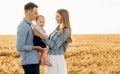 Happy family, mother, father and little child on the ripe wheat field Royalty Free Stock Photo