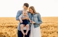 Happy family, mother, father and little child on the ripe wheat field Royalty Free Stock Photo