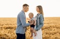 Happy family, mother, father and little child on the ripe wheat field Royalty Free Stock Photo