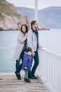 Happy family -mother, father and little son- walking in harbour Royalty Free Stock Photo