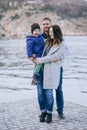 Happy family -mother, father and little son- walking in harbour Royalty Free Stock Photo