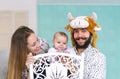 Happy family. Mother, the father in mask of a bull, baby son at home. Royalty Free Stock Photo