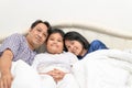 Happy Family mother father or parent and son lying on the bed Royalty Free Stock Photo