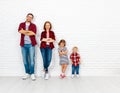 Happy family mother, father, son, daughter on a white blank wall Royalty Free Stock Photo