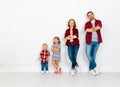 Happy family mother, father, son, daughter on a white blank wall Royalty Free Stock Photo