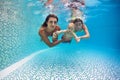 Happy family - mother, father, son dive underwater in swimming pool