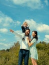 Happy family mother, father and son on sky background in summer. Cute boy with parents playing outdoor. Happy child Royalty Free Stock Photo
