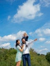 Happy family mother, father and son on sky background in summer. Cute boy with parents playing outdoor. Happy child Royalty Free Stock Photo