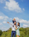 Happy family mother, father and son on sky background in summer. Cute boy with parents playing outdoor. Happy child Royalty Free Stock Photo