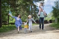 Happy family- mother,father and three children daughter little girls having fun on village road Royalty Free Stock Photo