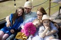 Happy family- mother,father and three children daughter relaxes on outdoor terrace of summer restaurant Royalty Free Stock Photo