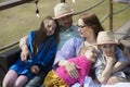 Happy family- mother,father and three children daughter relaxes on outdoor terrace of summer restaurant Royalty Free Stock Photo