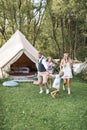 Happy family: mother, father, two children daughters on nature, dancing and running together. Cheerful family in boho Royalty Free Stock Photo