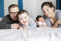 Happy family mother, father and two children at home in bed Royalty Free Stock Photo