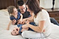 Happy family mother, father and two children at home in bed Royalty Free Stock Photo