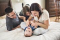 Happy family mother, father and two children at home in bed Royalty Free Stock Photo