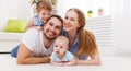 happy family mother, father and two children playing and cuddling at home Royalty Free Stock Photo
