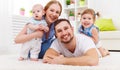 Happy family mother, father and two children playing and cuddlin Royalty Free Stock Photo