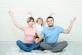 Happy family mother, father and two children playing and cuddling at home on floor Royalty Free Stock Photo