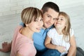 Happy family mother, father and two children playing and cuddling at home on floor. Unusually view from above. Royalty Free Stock Photo