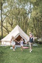 Happy family: mother, father, two daughters on nature on summer sunset, holding hands and posing on the background of Royalty Free Stock Photo