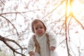 Happy family. mother hands throws up child in the blooming apple Royalty Free Stock Photo