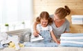 Happy family mother housewife and child daughter ironing clothes Royalty Free Stock Photo