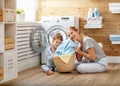 Happy family mother housewife and child in laundry with washin Royalty Free Stock Photo