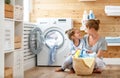 Happy family mother housewife and child in laundry with washin Royalty Free Stock Photo