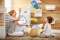 Happy family mother housewife and child in laundry with washin Royalty Free Stock Photo