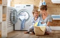 Happy family mother housewife and child in laundry with washin Royalty Free Stock Photo