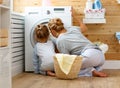 Happy family mother housewife and child in laundry with washin Royalty Free Stock Photo