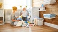 Happy family mother housewife and children in laundry load w