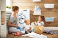 Happy family mother housewife and children in laundry load w