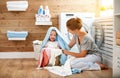 Happy family mother housewife and children in laundry load w