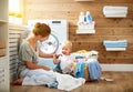 Happy family mother housewife and children in laundry load w