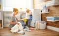 Happy family mother housewife and children in laundry load w