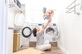 Happy family mother housewife in laundry room with washing machine throwing clothes up Royalty Free Stock Photo
