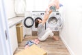 Happy family mother housewife in laundry room with washing machine throwing clothes up Royalty Free Stock Photo