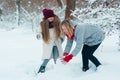 Happy family mother and kid daughter having fun, playing snowballs at winter walk Royalty Free Stock Photo